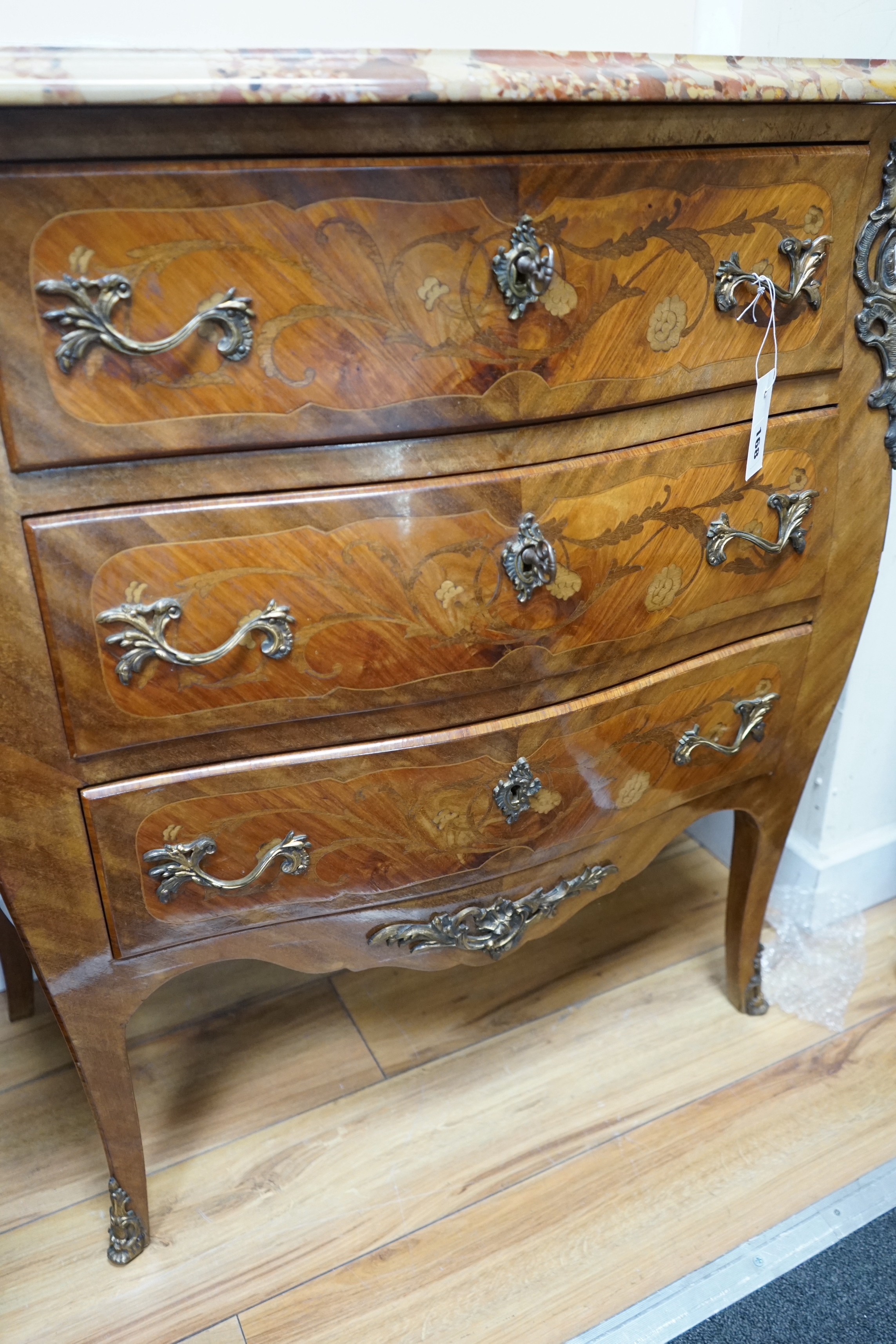 A Louis XV style marquetry inlaid marble topped serpentine three drawer commode, width 83cm, depth 40cm, height 87cm